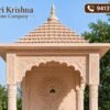 Pink stone temple front view with floral arch carving
