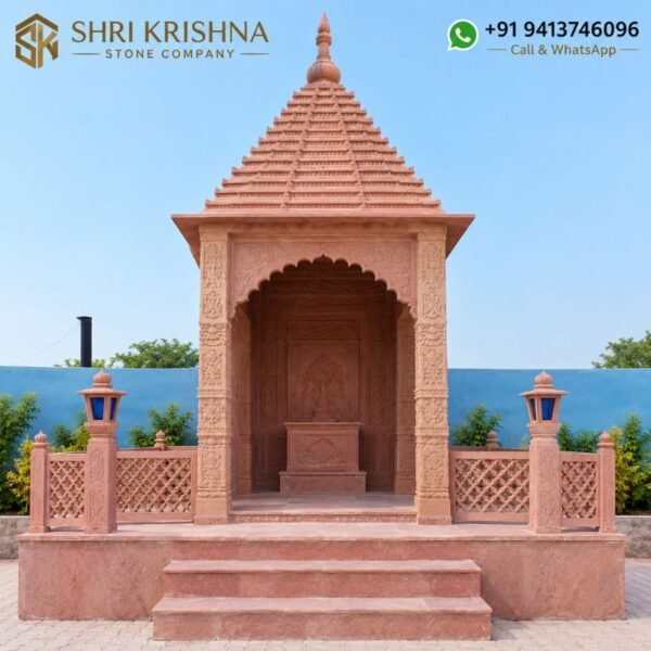 Side view of red stone mandir with traditional stone carving